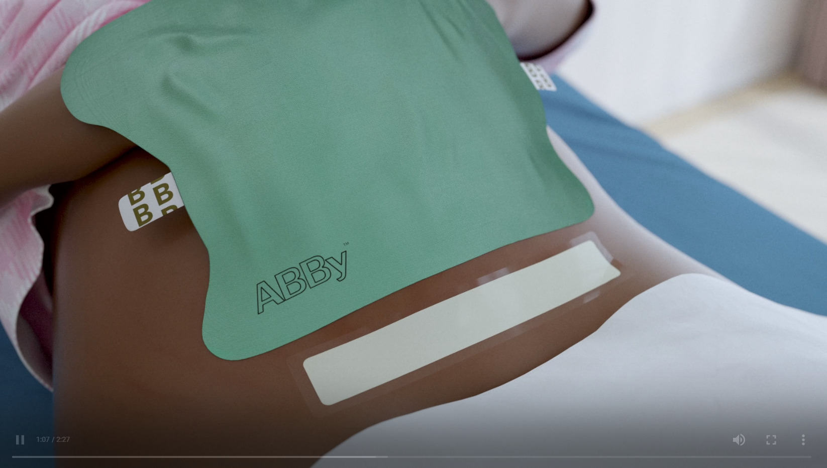 a green abby bandage is on a person 's stomach